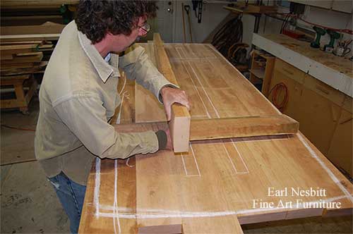 Earl chalks base of table with battons Earl chalks base of table with battons